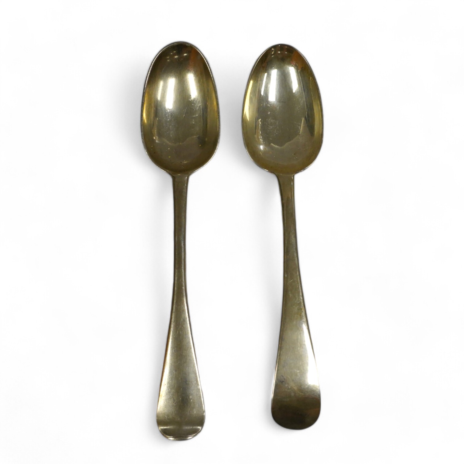 A George I silver Old English pattern table spoon, rubbed maker's mark, London, 1721 and a George III Irish silver table spoon, Dublin, 1760, 136 grams. Condition - fair